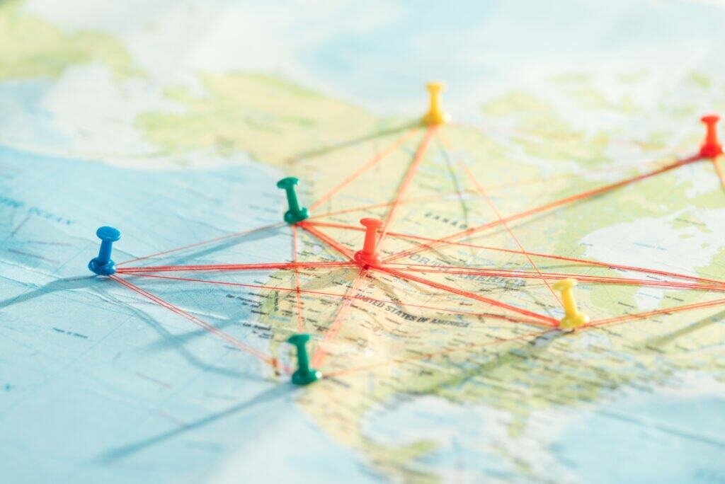 push pins and strings on world map