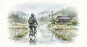 Watercolour illustration of a lone cyclist riding a bicycle on a quiet wet Japanese countryside road in the rain.